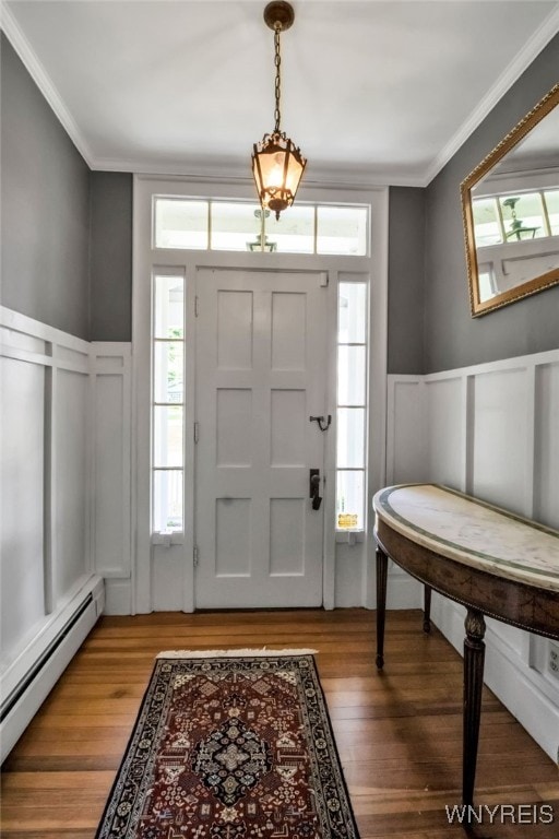 2565 Bowen Rd, Elma, NY 14059 - entryway with a baseboard radiator, a decorative wall, ornamental molding, wainscoting, and light wood-style flooring