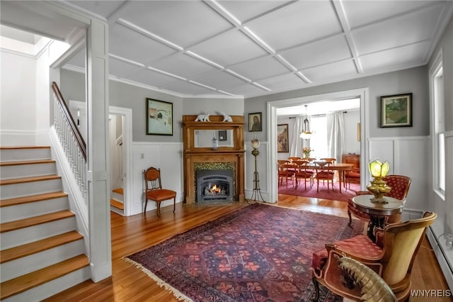2565 Bowen Rd, Elma, NY 14059 - living area with baseboard heating, stairs, wood finished floors, coffered ceiling, and wainscoting