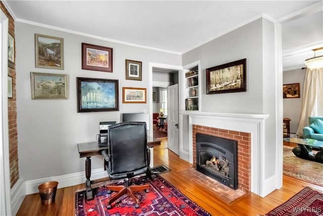 2565 Bowen Rd, Elma, NY 14059 - home office with wood finished floors, ornamental molding, built in shelves, and a fireplace