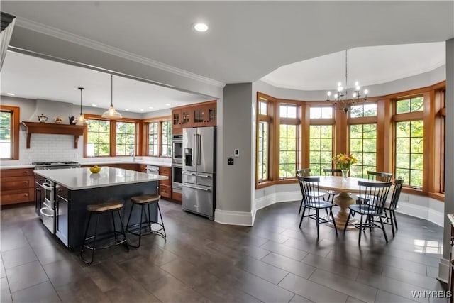 2565 Bowen Rd, Elma, NY 14059 - kitchen featuring appliances with stainless steel finishes, open shelves, light countertops, a chandelier, and crown molding
