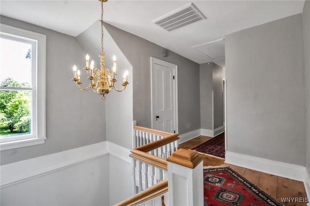 2565 Bowen Rd, Elma, NY 14059 - staircase featuring attic access, a chandelier, and wood finished floors