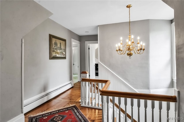 2565 Bowen Rd, Elma, NY 14059 - hallway featuring an upstairs landing, baseboard heating, a chandelier, and wood finished floors