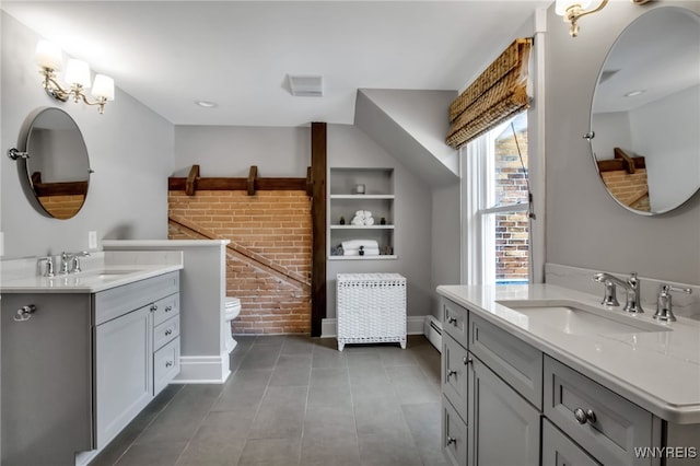 2565 Bowen Rd, Elma, NY 14059 - bathroom with two vanities, tile patterned floors, built in features, brick wall, and a baseboard radiator