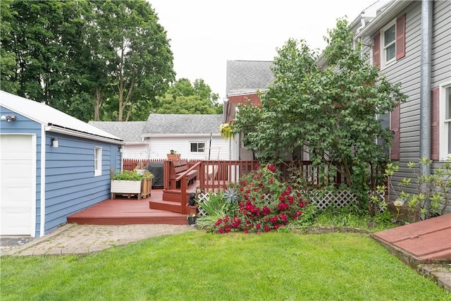 11 Fulton St, North Dansville, NY 14437 - view of green lawn with a deck, an outbuilding, and a garage