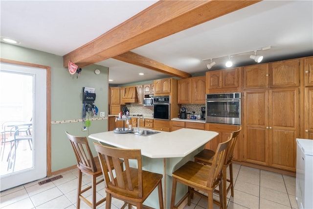 11 Fulton St, North Dansville, NY 14437 - kitchen featuring stainless steel appliances, light tile patterned floors, decorative backsplash, light countertops, and beam ceiling