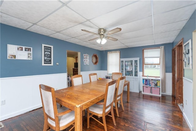 11 Fulton St, North Dansville, NY 14437 - dining area featuring a paneled ceiling, a wainscoted wall, a ceiling fan, and wood finished floors