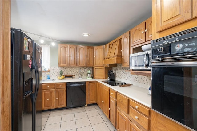 11 Fulton St, North Dansville, NY 14437 - kitchen featuring black appliances, light tile patterned floors, light countertops, and backsplash