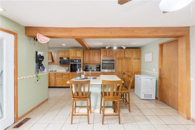 11 Fulton St, North Dansville, NY 14437 - kitchen with stainless steel appliances, light countertops, tasteful backsplash, light tile patterned floors, and recessed lighting
