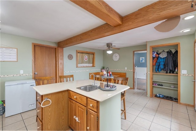 11 Fulton St, North Dansville, NY 14437 - kitchen with refrigerator, ceiling fan, light tile patterned flooring, beam ceiling, and light countertops