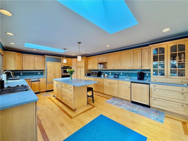 3 Suncrest Ter, Oneonta-City, NY 13820 - kitchen with light brown cabinets, a kitchen bar, stainless steel appliances, a skylight, and light wood finished floors