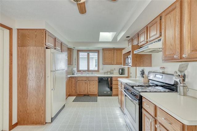 26 Catalina Dr, Irondequoit, NY 14622 - kitchen featuring stainless steel appliances, under cabinet range hood, light countertops, and a skylight