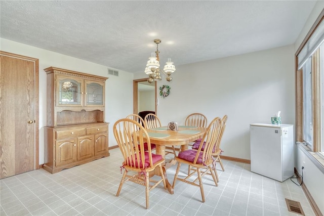 26 Catalina Dr, Irondequoit, NY 14622 - dining space with a chandelier, light flooring, and a textured ceiling