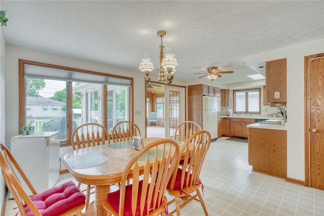 26 Catalina Dr, Irondequoit, NY 14622 - dining room with light floors, a textured ceiling, ceiling fan, and a chandelier