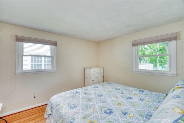 26 Catalina Dr, Irondequoit, NY 14622 - bedroom featuring multiple windows and wood finished floors