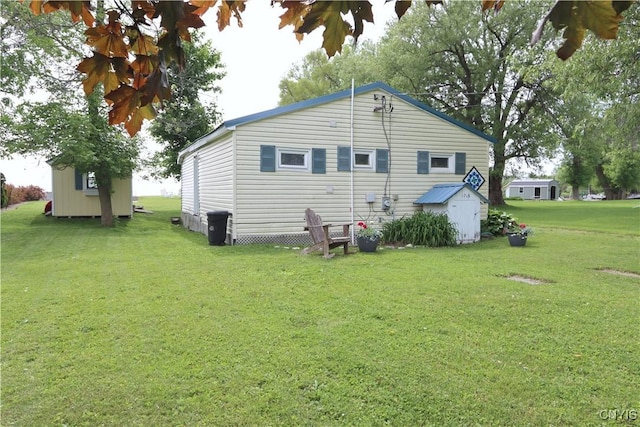 11713 Rays Bay Rd, Henderson, NY 13650 - rear view of property with a storage unit and a yard