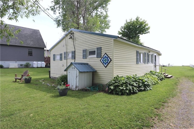 11713 Rays Bay Rd, Henderson, NY 13650 - view of side of home featuring a yard and a storage unit