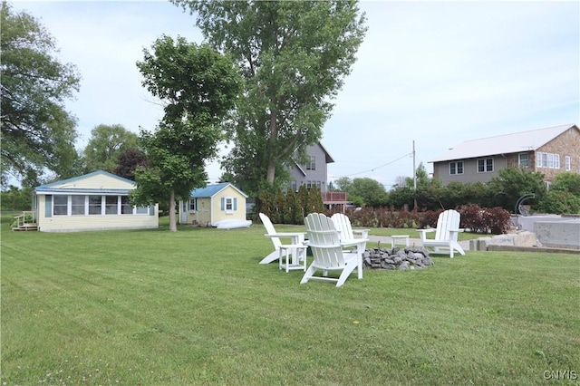 11713 Rays Bay Rd, Henderson, NY 13650 - view of green lawn with an outdoor fire pit and an outbuilding