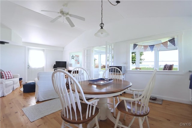 11713 Rays Bay Rd, Henderson, NY 13650 - dining space featuring vaulted ceiling, light wood finished floors, plenty of natural light, and a ceiling fan