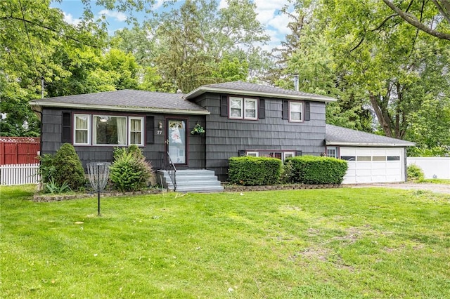 77 Chad Cir, Greece, NY 14616 - tri-level home featuring a garage, driveway, a shingled roof, and view of wooded area