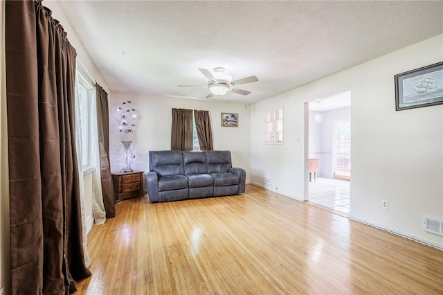 77 Chad Cir, Greece, NY 14616 - living area featuring light wood-style flooring, plenty of natural light, and a ceiling fan