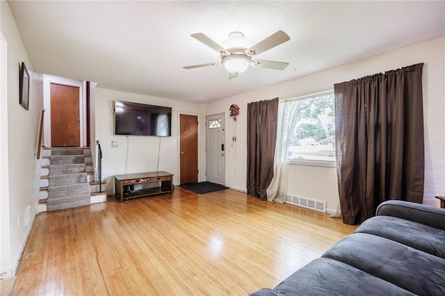 77 Chad Cir, Greece, NY 14616 - living area featuring light wood finished floors, stairway, and a ceiling fan