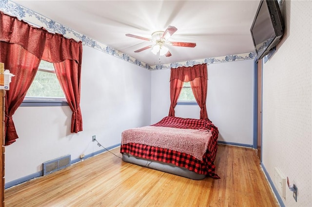 77 Chad Cir, Greece, NY 14616 - bedroom with wood finished floors, multiple windows, and a ceiling fan