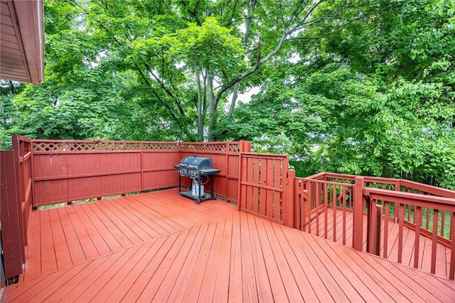77 Chad Cir, Greece, NY 14616 - wooden terrace featuring grilling area and view of wooded area