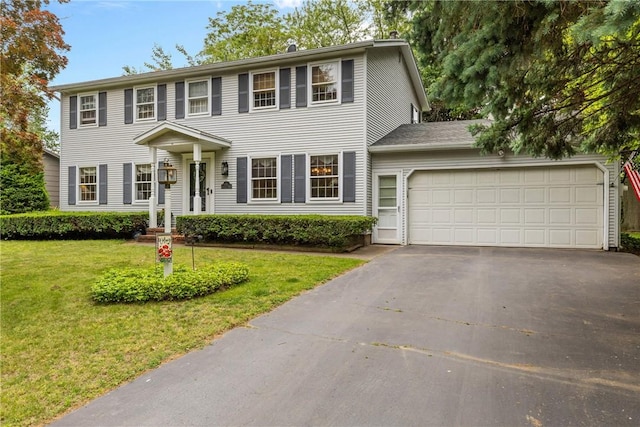 133 Parklands Dr, Greece, NY 14616 - colonial house featuring asphalt driveway, a garage, and a front yard