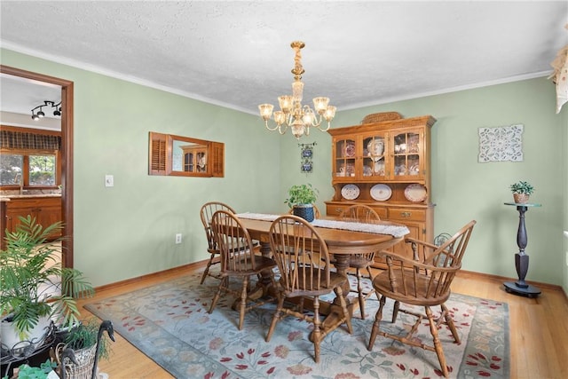 133 Parklands Dr, Greece, NY 14616 - dining space featuring a chandelier, wood finished floors, and ornamental molding