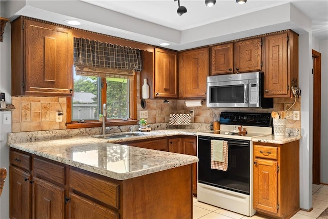 133 Parklands Dr, Greece, NY 14616 - kitchen featuring stainless steel microwave, electric range, brown cabinets, light stone countertops, and recessed lighting