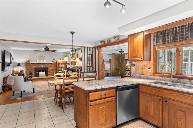 133 Parklands Dr, Greece, NY 14616 - kitchen with stainless steel dishwasher, ceiling fan, brown cabinets, light tile patterned floors, and open floor plan