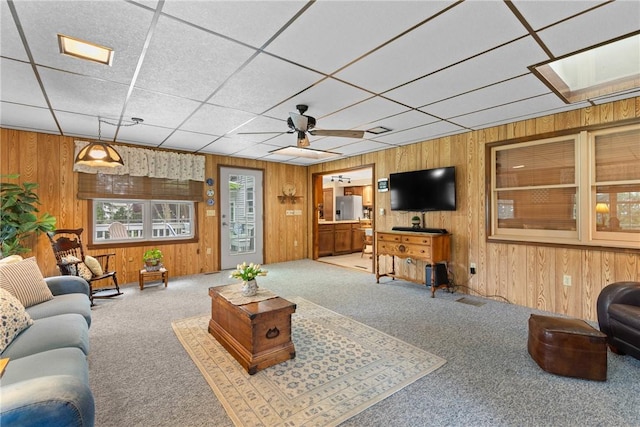 133 Parklands Dr, Greece, NY 14616 - carpeted living area featuring wood walls and a ceiling fan