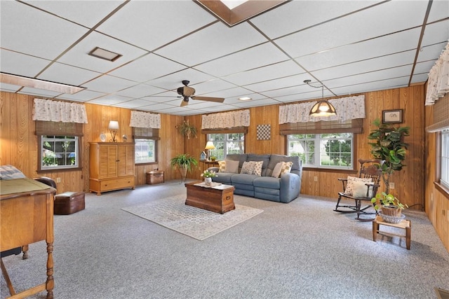 133 Parklands Dr, Greece, NY 14616 - carpeted living room with wood walls, ceiling fan, and a drop ceiling