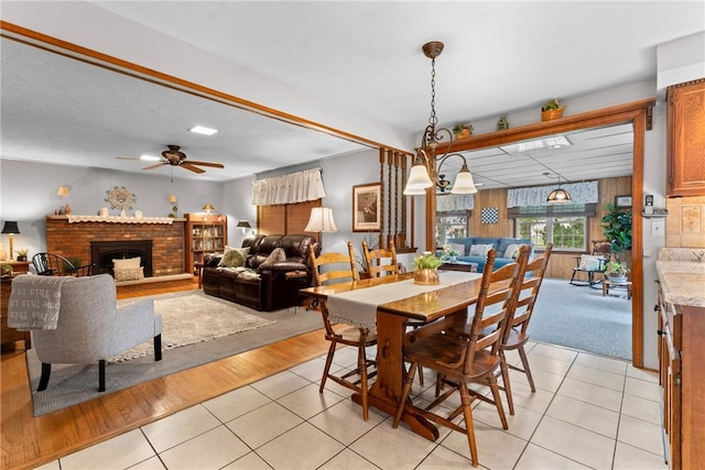 133 Parklands Dr, Greece, NY 14616 - dining space featuring light tile patterned floors, a ceiling fan, and a brick fireplace