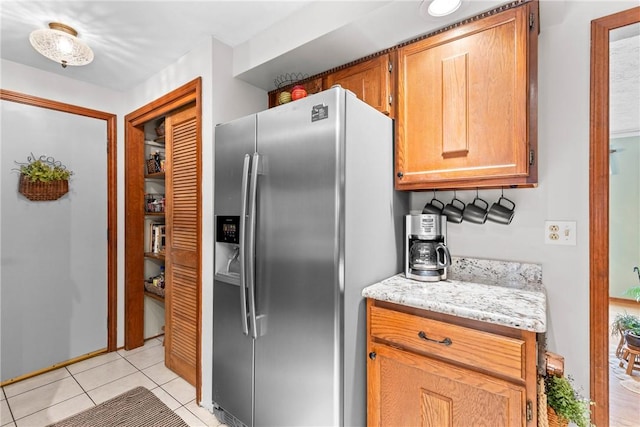 133 Parklands Dr, Greece, NY 14616 - kitchen featuring stainless steel refrigerator with ice dispenser, light tile patterned floors, and light stone counters