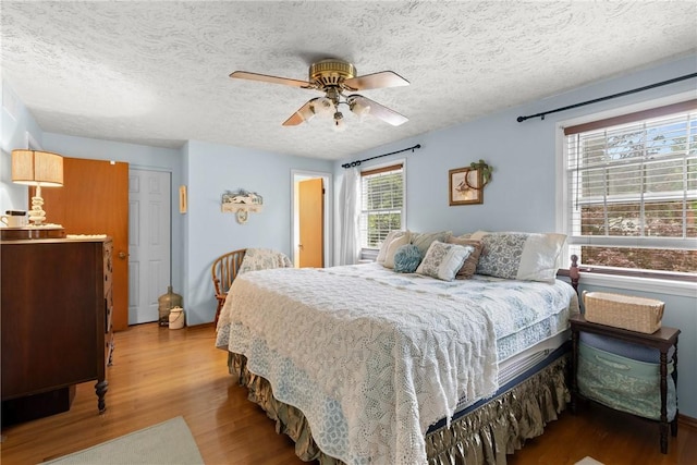 133 Parklands Dr, Greece, NY 14616 - bedroom with wood finished floors, a textured ceiling, and ceiling fan