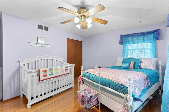 133 Parklands Dr, Greece, NY 14616 - bedroom with wood finished floors, a textured ceiling, ceiling fan, and a closet
