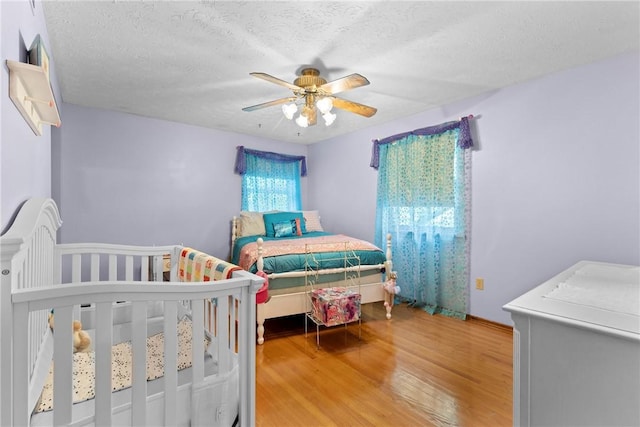133 Parklands Dr, Greece, NY 14616 - bedroom featuring wood finished floors, ceiling fan, and a textured ceiling