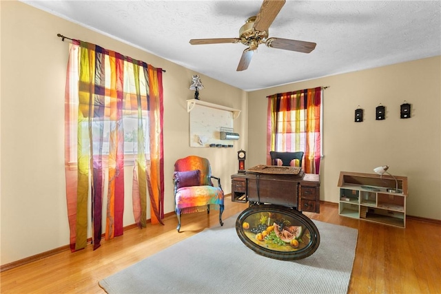 133 Parklands Dr, Greece, NY 14616 - living area with wood finished floors, ceiling fan, and a textured ceiling