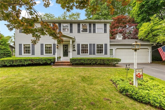133 Parklands Dr, Greece, NY 14616 - colonial house featuring driveway, a garage, and a front lawn