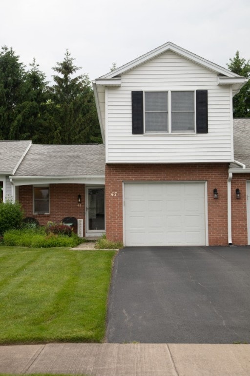 47 Flower Dale Cir, Greece, NY 14626 - view of front of home featuring brick siding, a front yard, asphalt driveway, and a garage