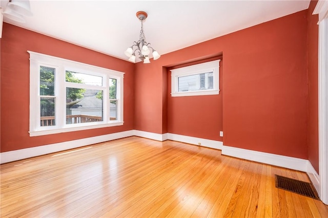 34 Shepard St, Rochester, NY 14620 - empty room with a chandelier and light wood-style flooring
