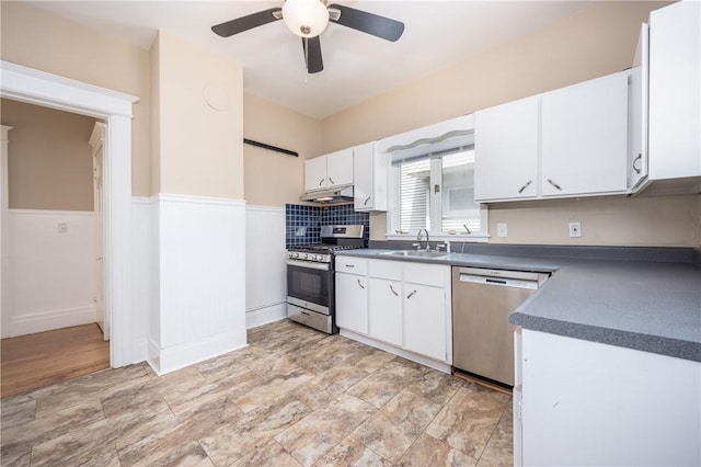 34 Shepard St, Rochester, NY 14620 - kitchen with stainless steel appliances, under cabinet range hood, dark countertops, ceiling fan, and white cabinets