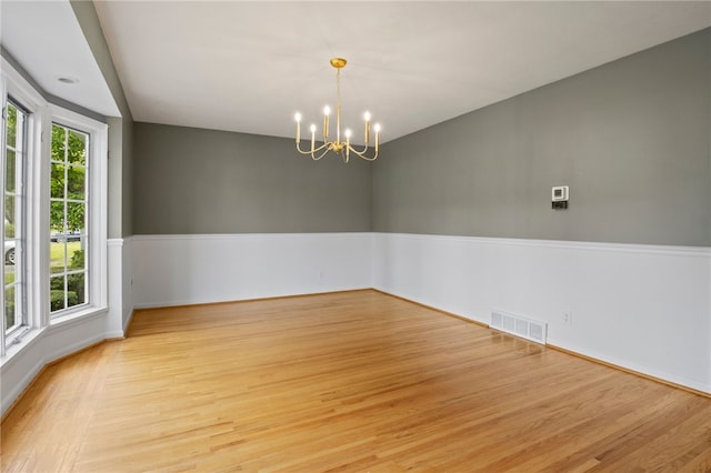 38 Moroa Dr, Irondequoit, NY 14622 - empty room with a chandelier and light wood-style floors