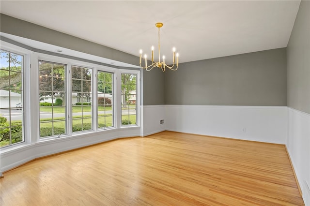 38 Moroa Dr, Irondequoit, NY 14622 - empty room with a chandelier, plenty of natural light, and light wood-type flooring