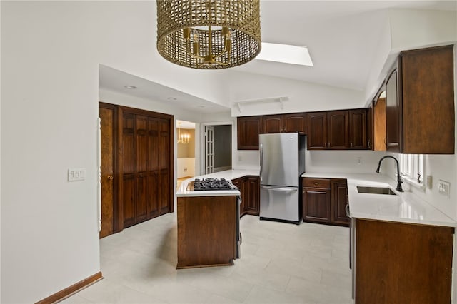 38 Moroa Dr, Irondequoit, NY 14622 - kitchen with freestanding refrigerator, light countertops, a chandelier, dark brown cabinets, and high vaulted ceiling