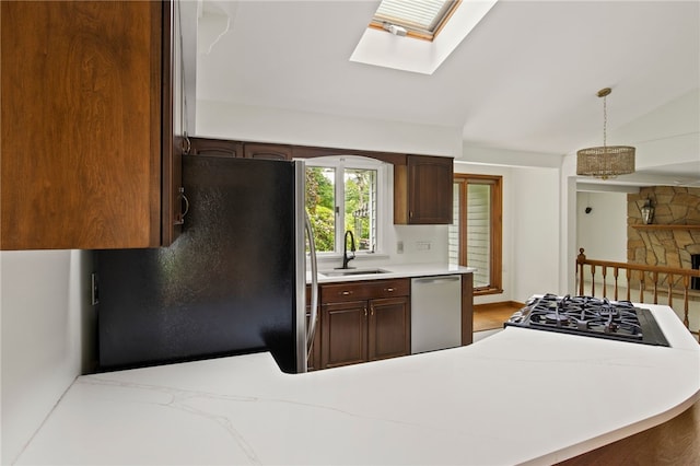 38 Moroa Dr, Irondequoit, NY 14622 - kitchen with freestanding refrigerator, stainless steel dishwasher, light countertops, a skylight, and pendant lighting
