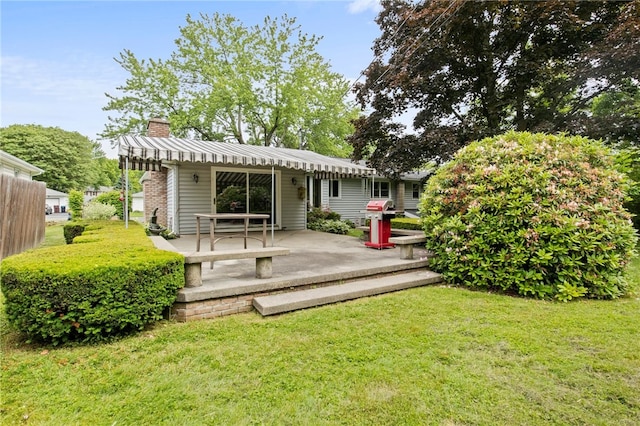 38 Moroa Dr, Irondequoit, NY 14622 - rear view of property featuring a yard, a chimney, and a patio area