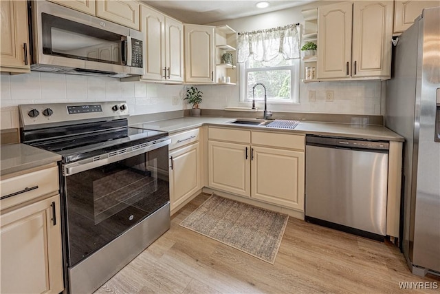 1558 Youngstown Wilson Rd, Porter, NY 14174 - kitchen with stainless steel appliances, open shelves, light wood finished floors, decorative backsplash, and recessed lighting