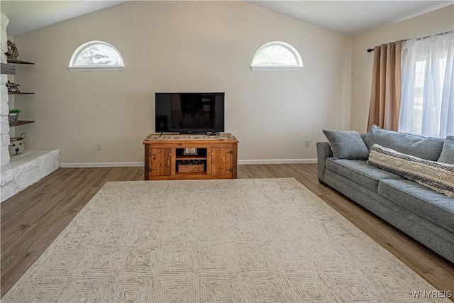 1558 Youngstown Wilson Rd, Porter, NY 14174 - living room featuring wood finished floors, healthy amount of natural light, and vaulted ceiling